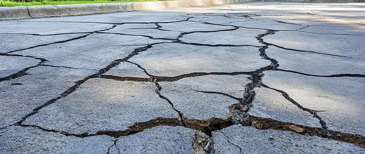 Cracked concrete surface outdoors showing area suitable for flatwork repair or resurfacing in Washington.